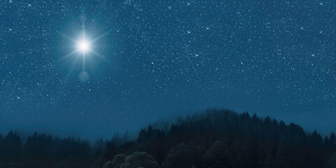 The star shines over the manger of christmas of Jesus Christ.