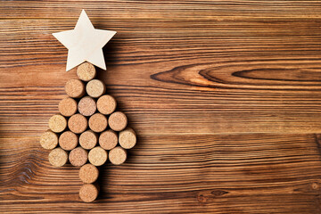 Christmas tree from wine corks with a star on top on a wooden background