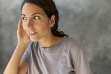 Close-up of pretty curious female eavesdropping to hear gossip or rumors, smiling, feeling excited...