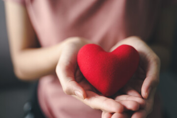 Woman holding red heart, love, health insurance, donation, happy charity volunteer, world mental health day, world heart day, valentine's day