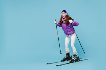 Full body skier scared fearful panicked woman 20s wear warm purple padded windbreaker jacket ski...