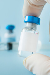 medical vaccine vials or bottles on table top over gray background. blank vial template for label....