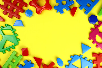 Frame of children's educational toys on a yellow background. Copy space for text