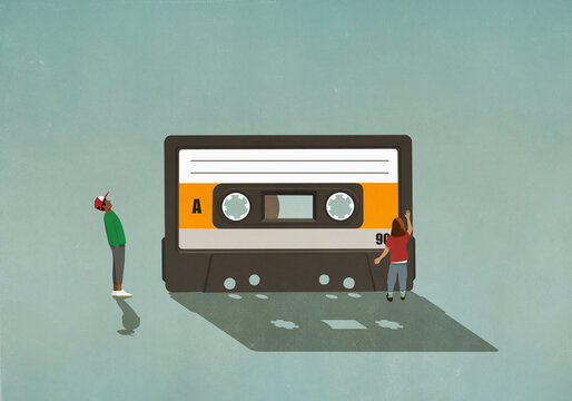 Boy and girl looking at cassette tape

