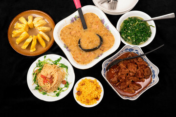 Rich menu, various dishes on black background.