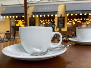 Cose up of a coffee cup on the table at outdoors cafe