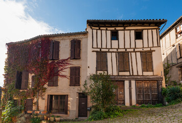 Fototapeta na wymiar Old street and house facade in the medieval village of Cordes sur Ciel, in the Tarn, in Occitanie, France