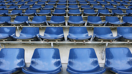 Blue empty seats on grandstand stadium background.