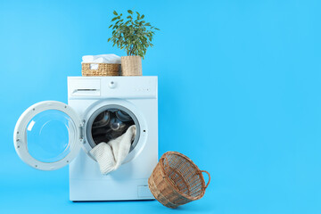 Concept of housework with washing machine on blue background