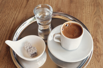 Traditional Turkish coffee with cold water and Turkish delight