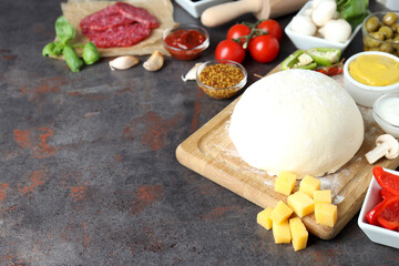 Concept of cooking pizza on dark textured background