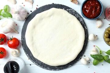Concept of cooking pizza on white wooden background