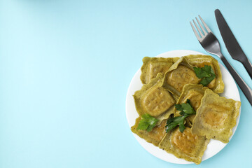Delicious food concept with ravioli on blue background