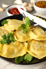 Delicious food concept with ravioli on gray background