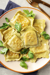 Delicious food concept with ravioli on gray background