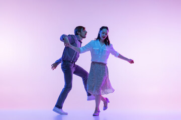 Couple of dancers, young man and woman in vintage retro style outfits dancing swing dance isolated...