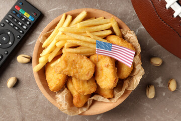 Naklejka premium Concept of Super bowl snacks on textured background