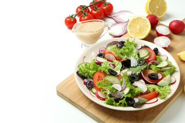 Concept of tasty food with vegetable salad with tahini sauce on white background