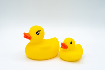 Pair of yellow ducks with red beaks baby bath toy isolated on white background