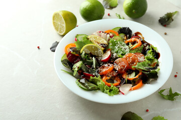 Concept of tasty food with vegetable salad with tahini sauce on light textured background