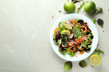 Concept of tasty food with vegetable salad with tahini sauce on light textured background