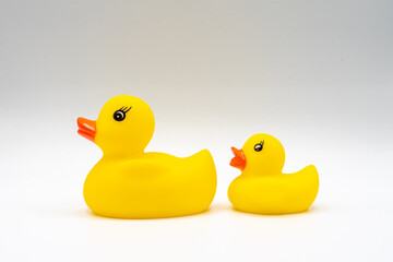 Pair of yellow ducks with red beaks baby bath toy isolated on white background