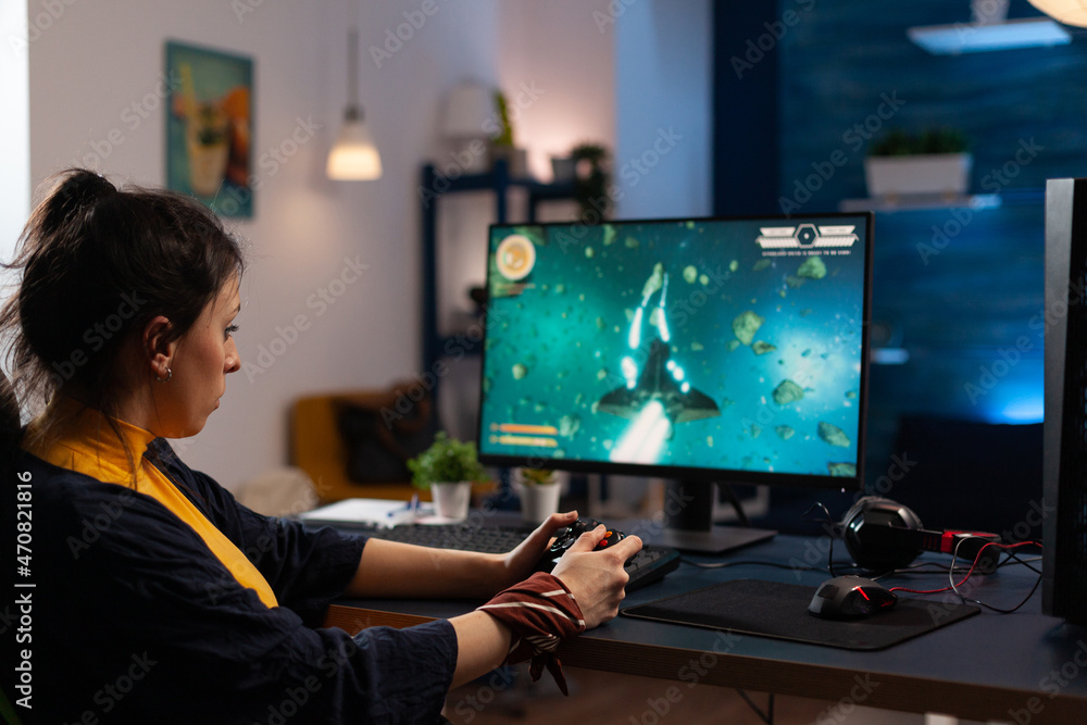 Poster adult playing video games with controller on computer. cheerful woman using joystick to play online 
