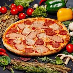Top view pizza on table top, Flat lay of pizza on black background, Prepared pizza on table for serve Freshly baked homemade pizza isolated on a black background with vegetables. View from above