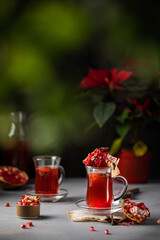 Hot Turkish pomegranate tea with seeds, anise vertical photo. Vitamin hot drink beverage. Copy space banner text template