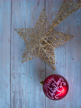 Golden star with red Merry Christmas ball