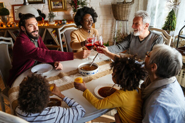 Fototapeta premium Happy multiethnic family having a holiday dinner together.