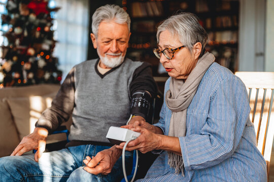 Senior couple at home measuring blood pressure. Home monitoring people healthcare concept - Powered by Adobe