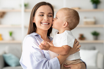 Mother Child Love. Cute Little Baby Boy Kissing Happy Mom At Home