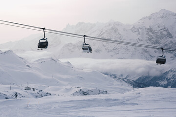 Fototapeta na wymiar Winter mountains panorama with ski slopes and ski lifts