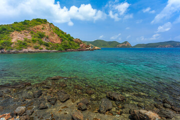 Tropical island rock on the beach with blue sky. Koh kham pattaya thailand 
