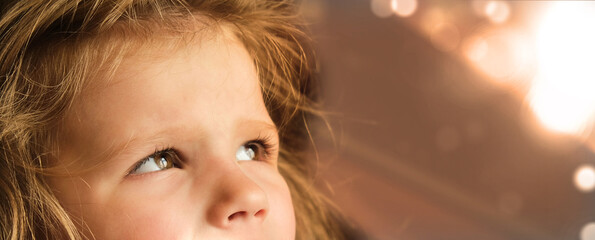 Closeup eyes of little girl looking up  to ask for blessing from God.