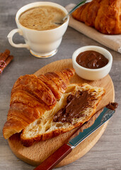 Croissant with chocolate and cappuccino