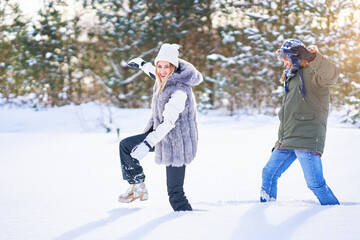 Couple walking in high snow during winter