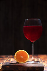 glass of red wine on wooden table