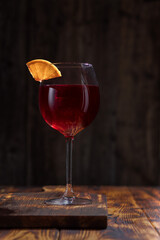 glass of red wine on wooden table
