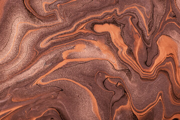 Abstract fluid art background dark brown and bronze colors. Liquid marble. Acrylic painting with umber gradient.