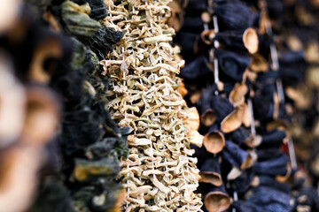 Dried eggplants hanging on threads for sell, selective focus