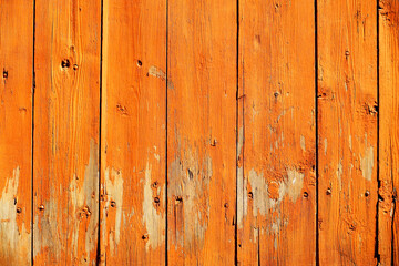 Fototapeta premium Wooden ocher background. Old barn wall with peeling paint
