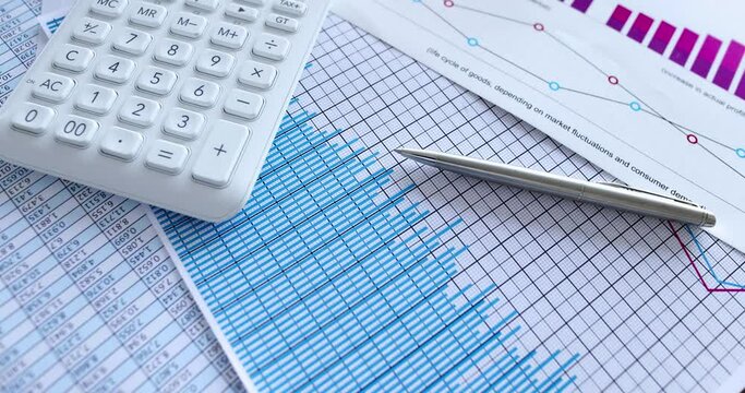 Calculator with business charts and reporting statistics on table slow motion 4k movie