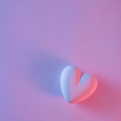 3d pink heart shape with shadow on pastel purple background