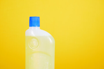 floor cleaning disinfect bottle against yellow background 