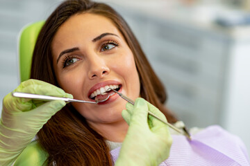 Smiling young woman at the dentist chair