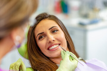 Smiling young woman at the dentist chair