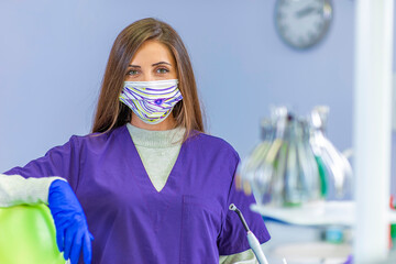 Young female dentist holding dental tools in her clinic