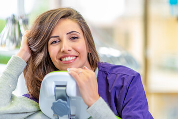 Young smiling woman at the dentist chair